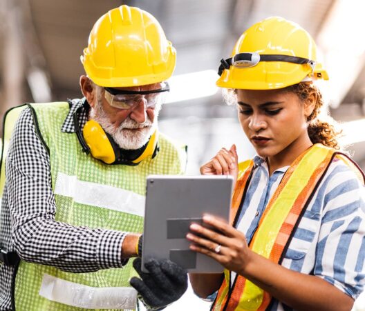 Industrial Engineers in Hard Hats looking at tablet